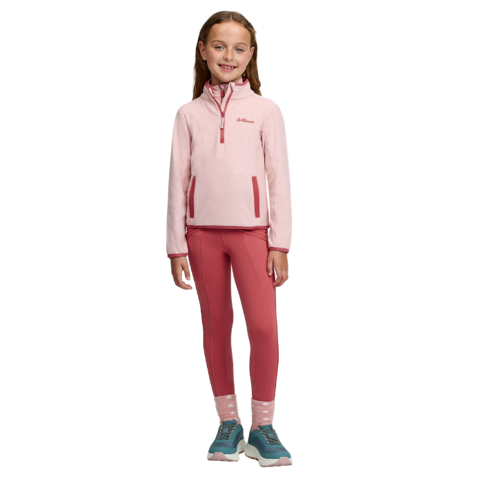 LeMieux AW26 Mini Maggie Heart Fleece Varient Petal. Young girl weareing a pink fleece and ret bottoms on a white background. 