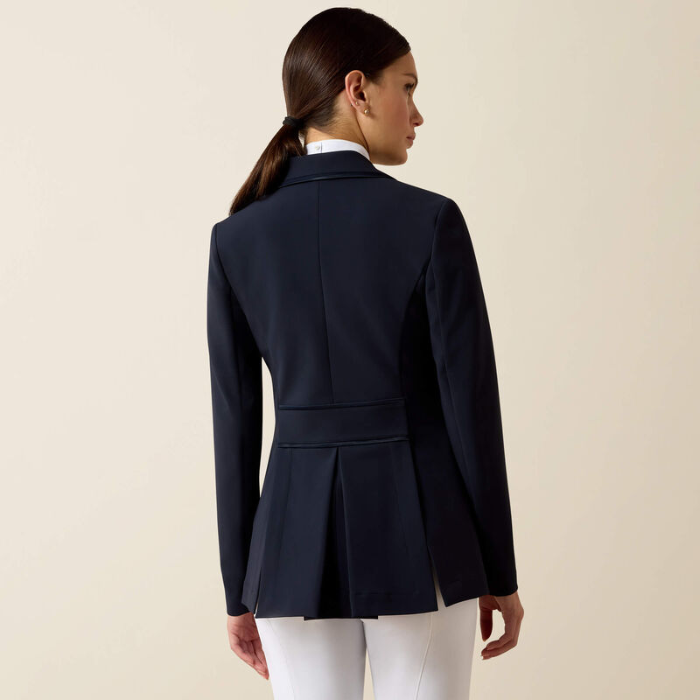 Woman wearing navy blazer and white shirt on beige background