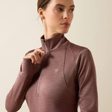 Ariat Ladies Team EQ 1/2 Zip Pullover Variant Twilight Mauve. A woman wearing a long-sleeve athletic quarter-zip pullover in a muted mauve-brown color, shown from the chest up against a plain light beige studio background.