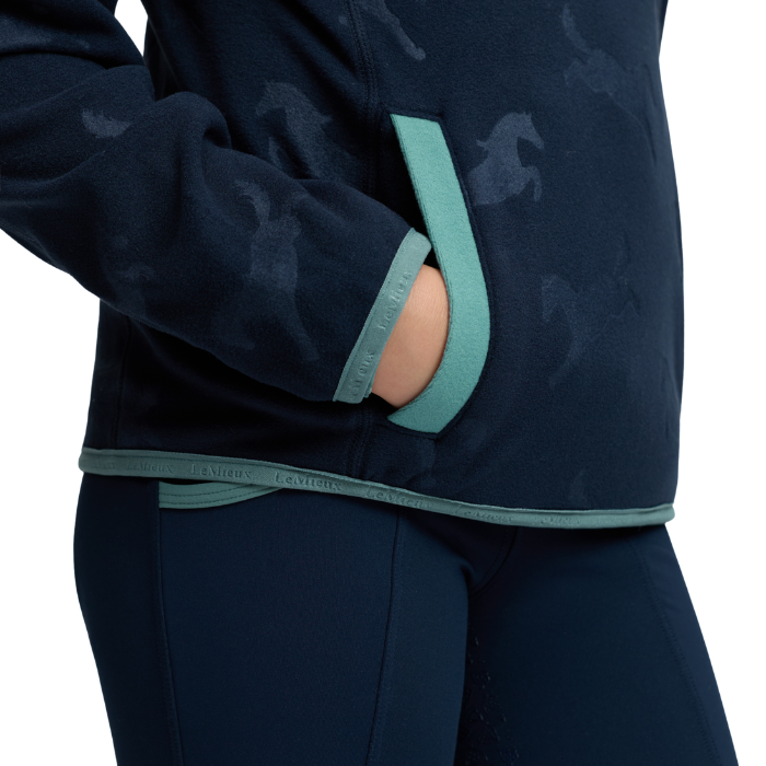 LeMieux AW26 Mini Maggie Horse Fleece Varient Navy. Close up of fleece pocket with aqua piping. 