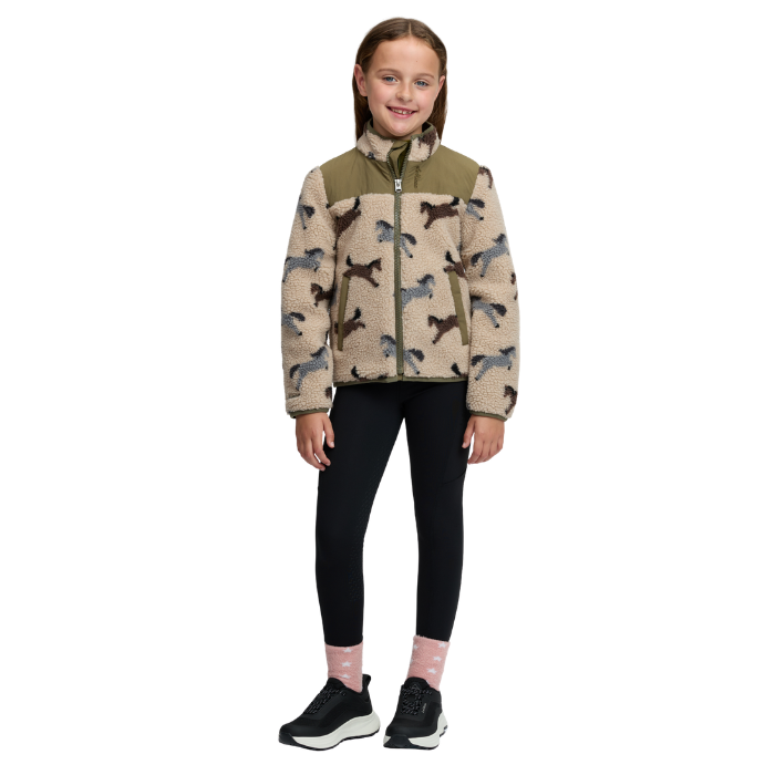 LeMieux AW26 Mini Theo Pony Fleece Varient Willow Green. A young girl stands against a plain white background wearing a fleece jacket with a horse pattern, black leggings, pink socks, and black sneakers.