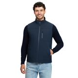 LeMieux AW26 Mens Midweight Insulated Gilet Varient Navy. A man wearing a navy blue zip-up vest over a matching navy long-sleeve shirt and light blue jeans, standing against a plain white background.