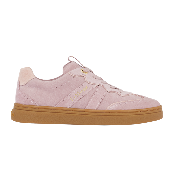 LeMieux AW26 Stockbridge Suede Trainers Variant Colour Wild Rose.
A light pink suede sneaker with a gum brown sole, featuring gold 'LE MiEUX' branding on the side, shown against a plain white background.