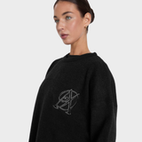 Person wearing a black sweater on a light grey background