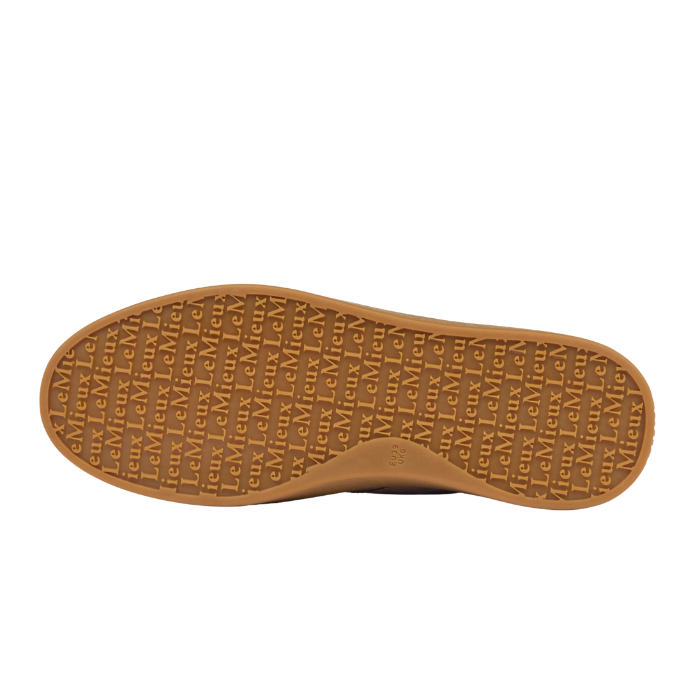 LeMieux AW26 Stockbridge Suede Trainers Variant Colour Wild Rose.
The outsole of a brown shoe, featuring a textured pattern of repeating embossed 'LeMieux' brand names, shown against a plain white background.