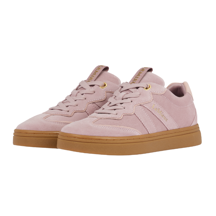 LeMieux AW26 Stockbridge Suede Trainers Variant Colour Wild Rose.
A pair of light pink suede sneakers with gum soles and gold branding details, shown against a plain white background.