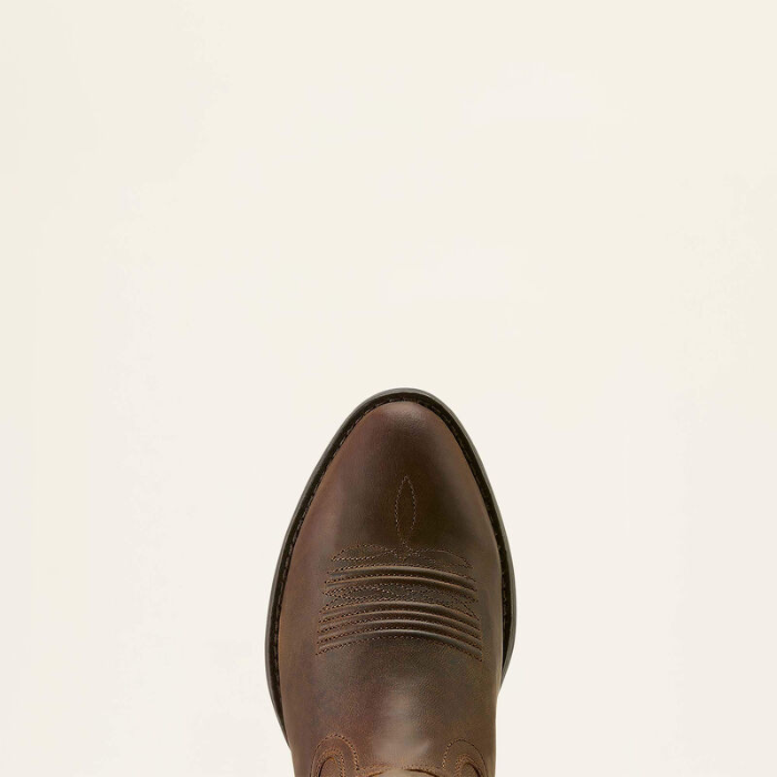 Ariat Ladies Heritage R Toe Western Boot Variant Colour Sassy Brown. The toe of a Western boot with decorative stitching and gold coloured material with R shaped toe on light cream background. 