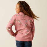 Girl wearing a pink jacket with horse print on a beige background