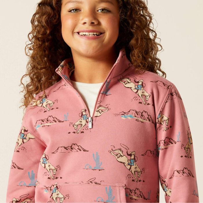 Child wearing a pink patterned sweatshirt with a white background