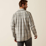 Man wearing a plaid shirt on a beige background