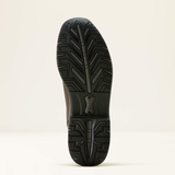 Black shoe sole with tread pattern on a light beige background
