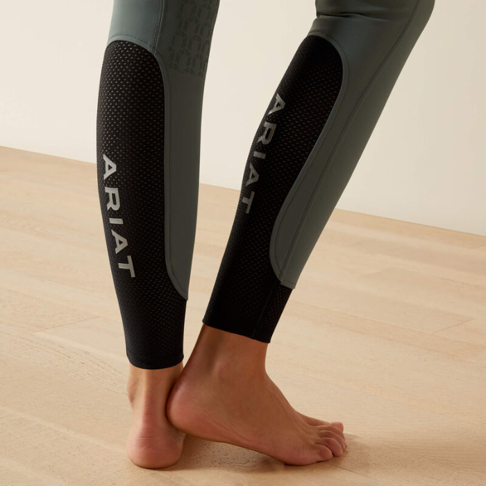 Black Ariat riding pants on a neutral background