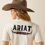 Person wearing a light Ariat t-shirt with a brown cowboy hat on a beige background