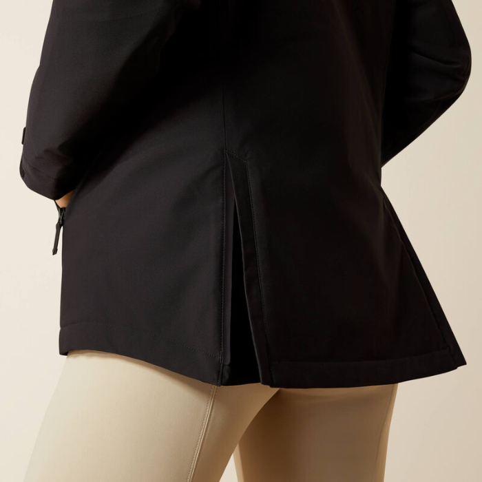 Black jacket worn by a person on a beige background