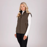 Woman wearing a brown gilet over a white shirt on a light grey background