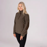 Woman wearing a brown pullover with a high collar on a light grey background