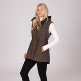 Woman wearing a brown gilet over a white shirt on a light grey background