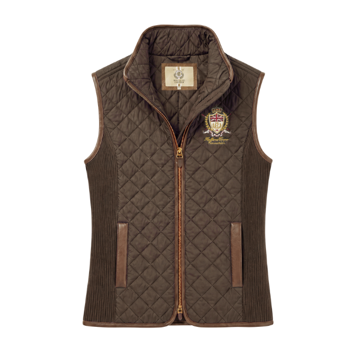Holland Cooper Boughton Diamond Quilt Gilet Variant Colour Walnut.
A brown quilted and corduroy vest with a full front zipper, zippered hand pockets, and embroidered branding on the left chest, shown against a plain white background.