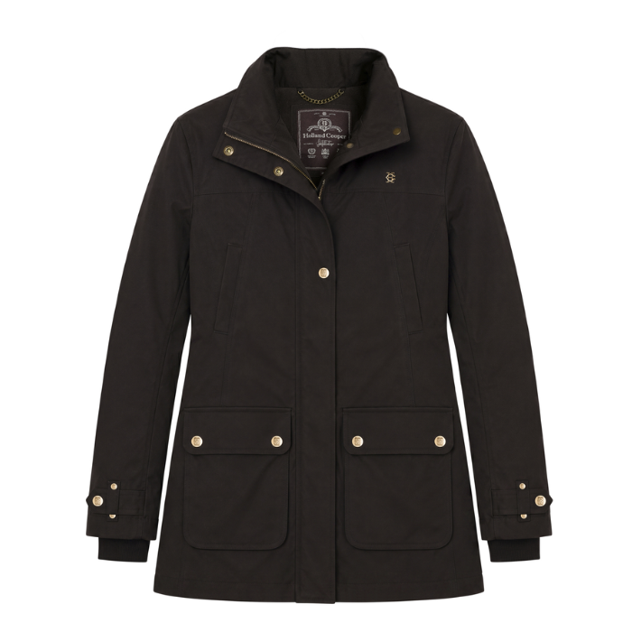 Holland Cooper Bramwell Waterproof Country Coat Variant Colour Bournville.
A brown waxed cotton utility jacket with gold-tone snap buttons and a small embroidered logo on the left chest, displayed against a solid white background.