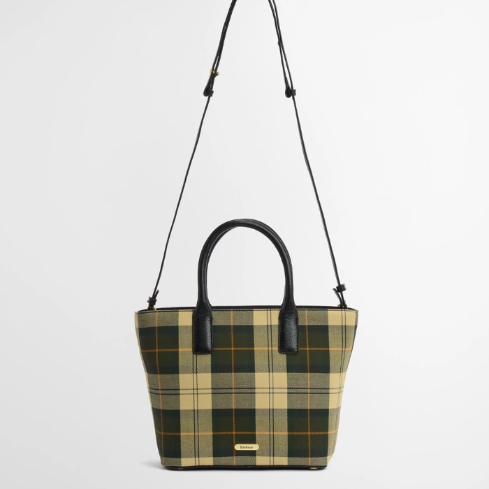 Tartan tote bag with black leather handles and cross body strap on a white background