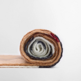 Rolled-up colorful fabric on a white background