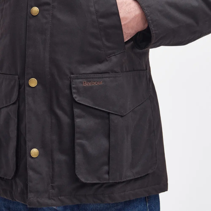 Dark jacket with gold buttons and 'Barbour' branding on a white background