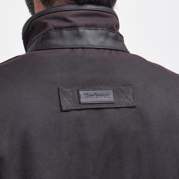 Dark jacket with Barbour logo on a light gray background