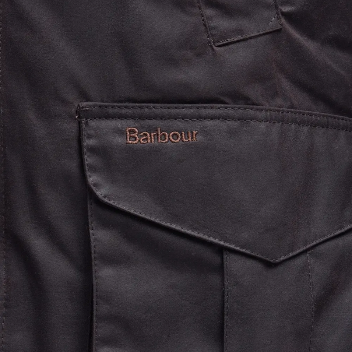 Close-up of a dark jacket with Barbour logo on a pocket