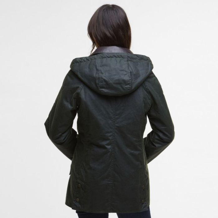Person wearing a dark green hooded Barbour jacket on a light gray background