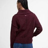 Person wearing a burgundy knitted jumper on a white background