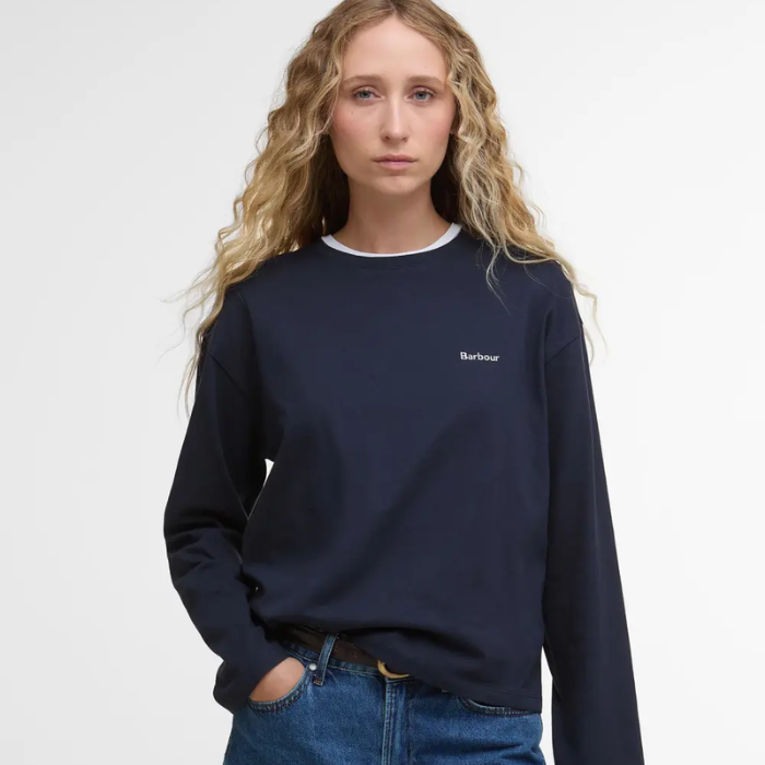 Person wearing a navy blue t-shirt with a Barbour logo on a white background