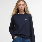 Person wearing a navy blue t-shirt with a Barbour logo on a white background