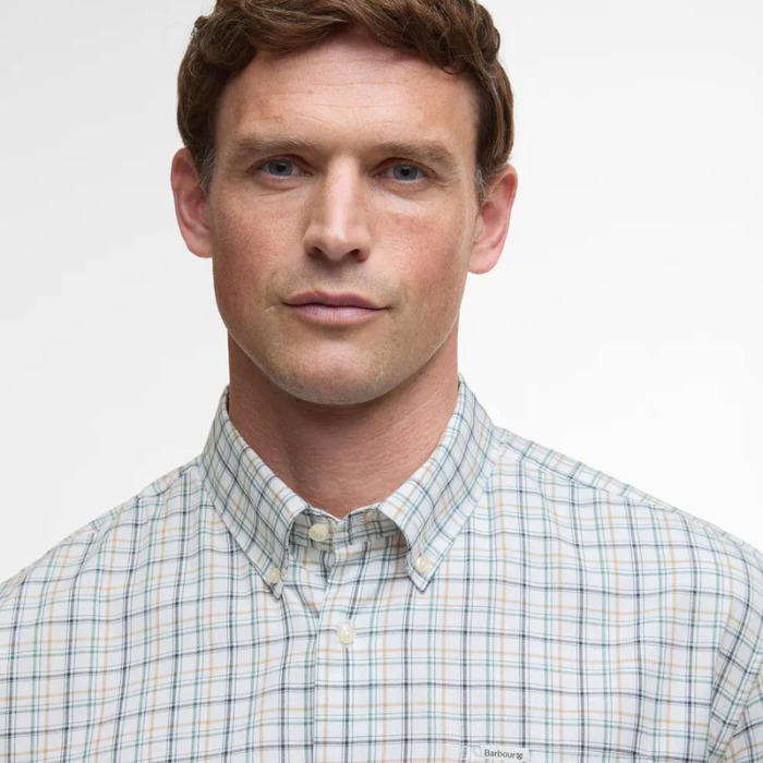 Man wearing a checked shirt with a plain background