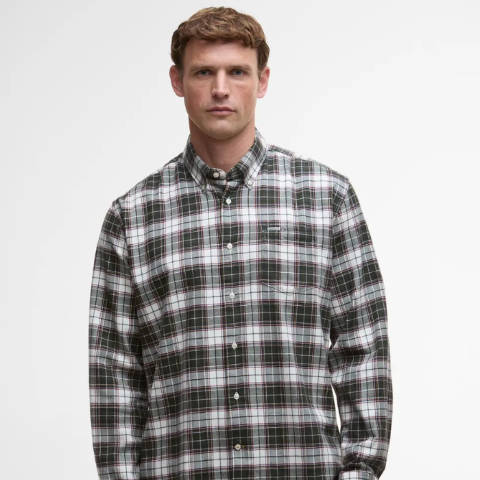 Man wearing a plaid Barbour shirt against a plain background