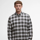 Man wearing a plaid Barbour shirt against a plain background