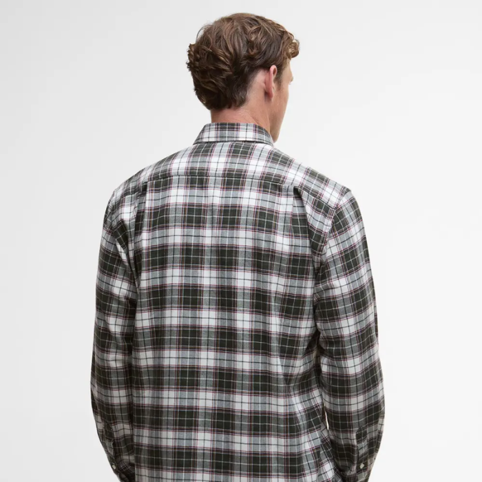Person wearing a plaid Barbour shirt on a plain background
