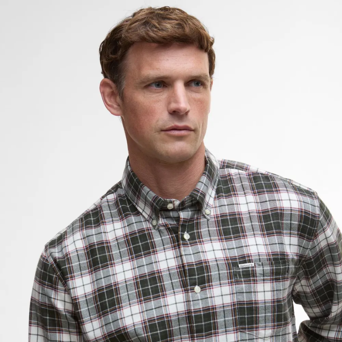 Man wearing a plaid Barbour shirt against a plain background