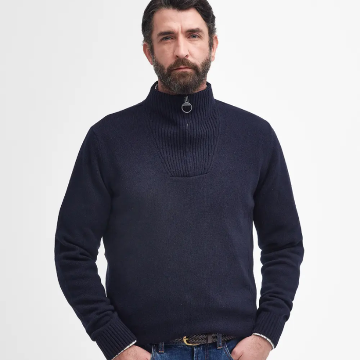 Man wearing a navy blue jumper on a light grey background