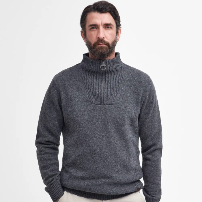 Man wearing a grey Barbour knitted jumper on a white background
