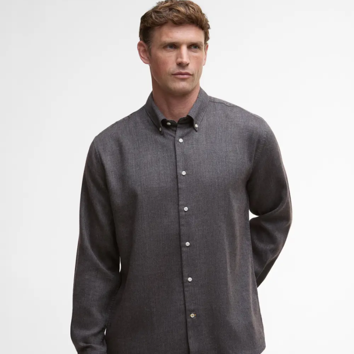 Man wearing a grey button-up shirt on a white background