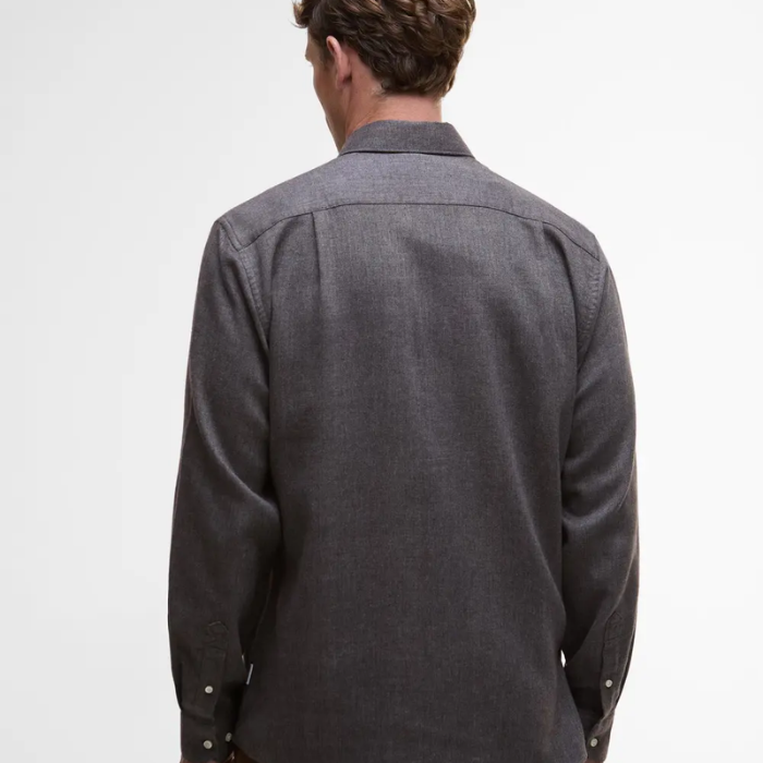 Person wearing a grey shirt on a white background