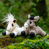 LeMieux AW26 Tiny Beanie Pony Daphne Variant Colour Beige. Two soft toy ponies sat on a log faded green background. 