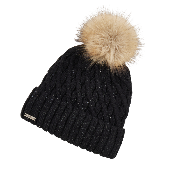 LeMieux AW26 Bernie Sequin Beanie Variant Colour Black.
A black cable-knit beanie hat with a fluffy tan faux-fur pom-pom on top, shown on a plain white background.