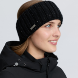 LeMieux AW26 Bernie Sequin Headband Variant Colour Black.
A woman in profile wearing a black ribbed knit winter headband with subtle silver glitter flecks and a small silver brand tag. She is also wearing a black hooded jacket against a light gray studio background.