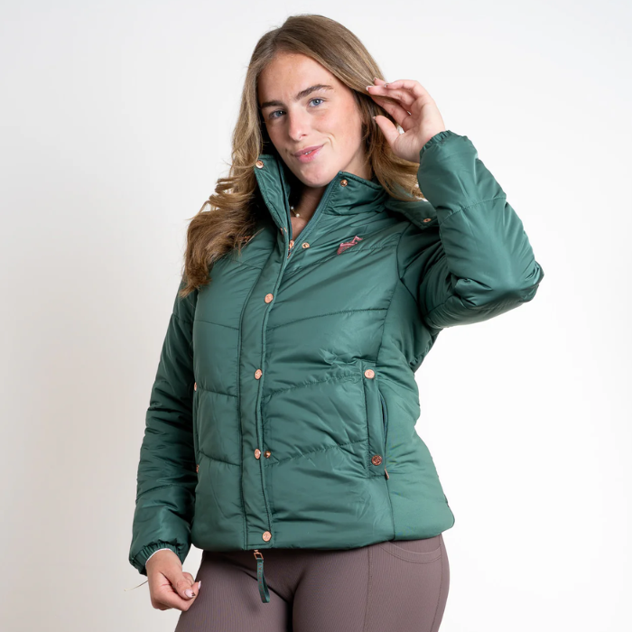 Woman wearing a green puffer jacket on a white background