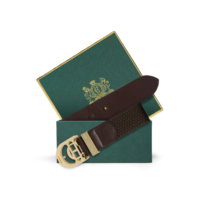 Holland Cooper Stirrup Heritage Belt Variant Colour Chocolate. A brown belt with CH gold buckle in a green box on white background. 