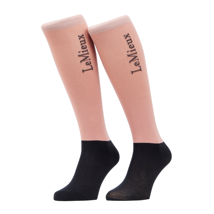 LeMieux AW26 Competition Socks 2 pack Variant Colour Wild Rose.
A pair of knee-high socks with a light pink upper leg section and a black foot section, featuring the brand name 'LeMieux' printed in black script on the pink portion, set against a plain white background.