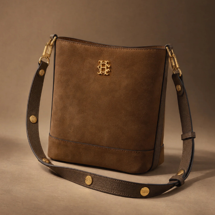 Brown Suede bag with gold detailing and Gold HC logo on a brown background.