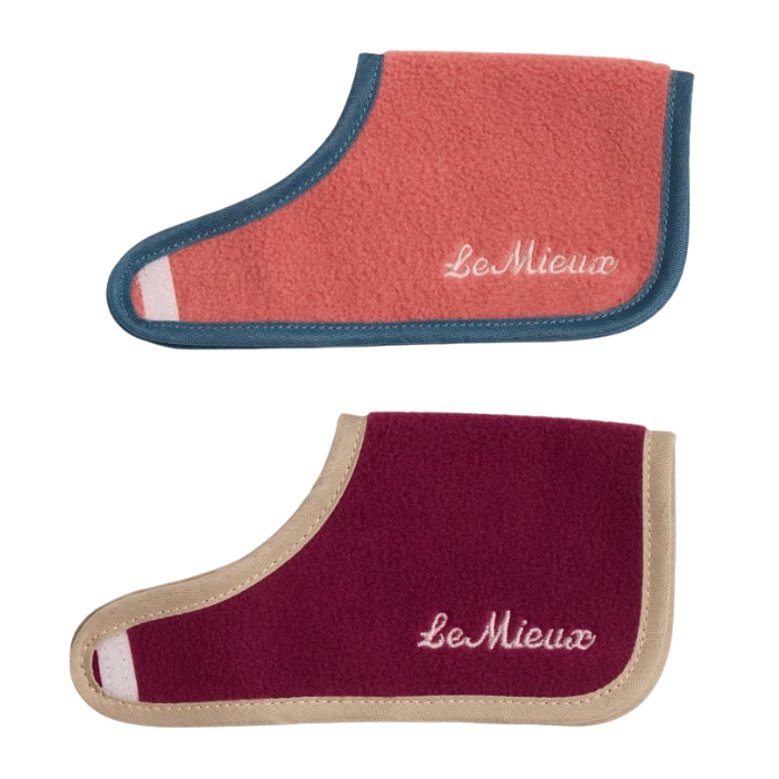 Two fleece horse rugs by LeMieux on a white background, one in coral pink with teal trim and one in burgundy with beige trim.