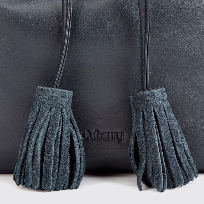navy suede tassels with a navy leather bag 